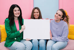 Women Holding a Blank Poster and Smiling  image 2