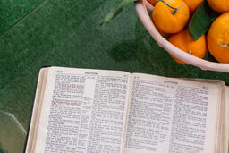 Bible Next to a Bowl of Oranges  image 1