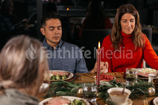 Family Praying Together Before the Christmas Meal