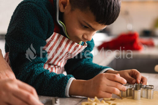 Young Boy Making Christmas Cookies