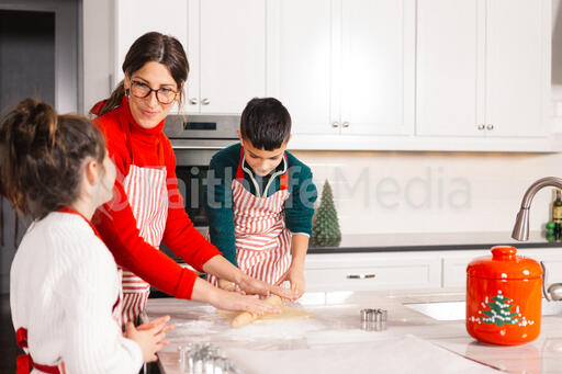 Mother and Children Baking Christmas Cookies Together