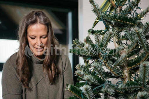 Woman with Gray Hair Decorating the Christmas Tree