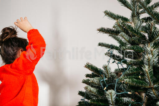 Young Girl Decorating the Christmas Tree