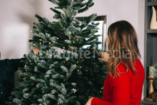 Woman Decorating a Christmas Tree