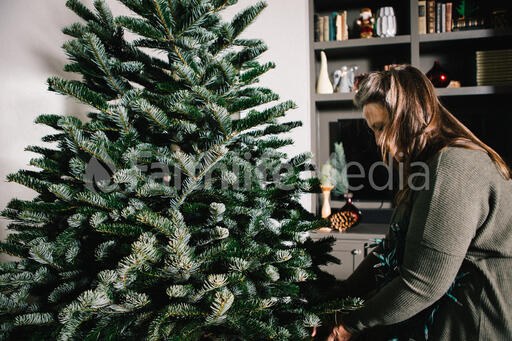 Woman Decorating a Christmas Tree