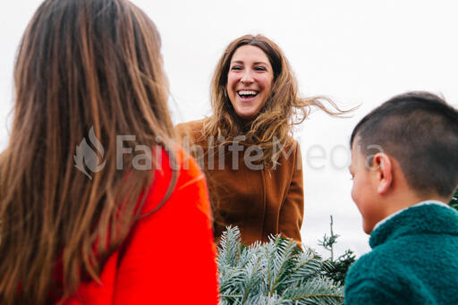 Mother Laughing with Her Children at a Christmas Tree Farm