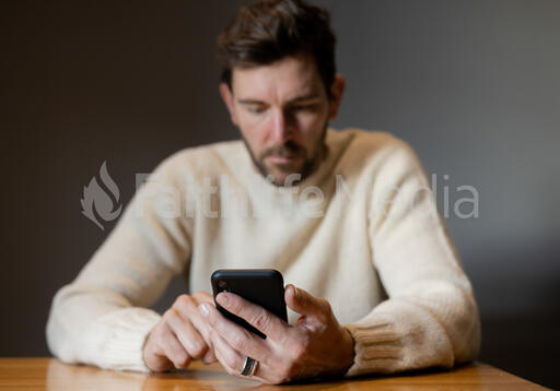 Man Scrolling on His Phone Alone