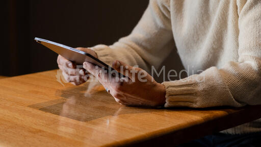 Man Reading on an iPad Alone