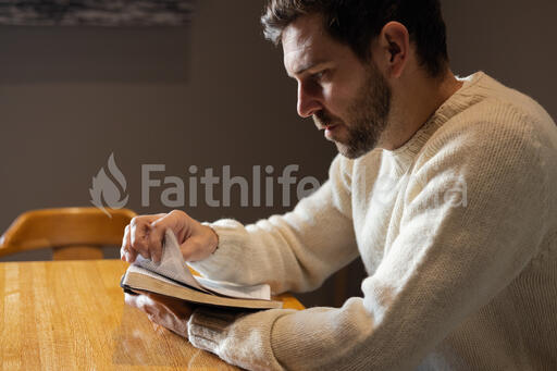 Man Reading the Bible Alone