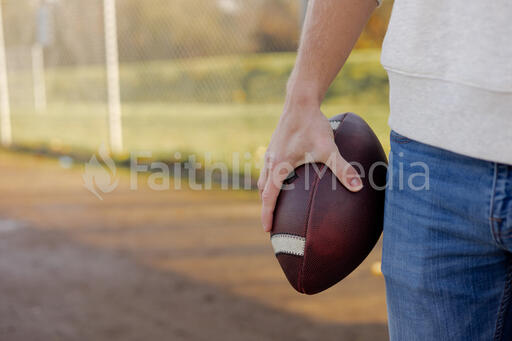 Man Holding a Football