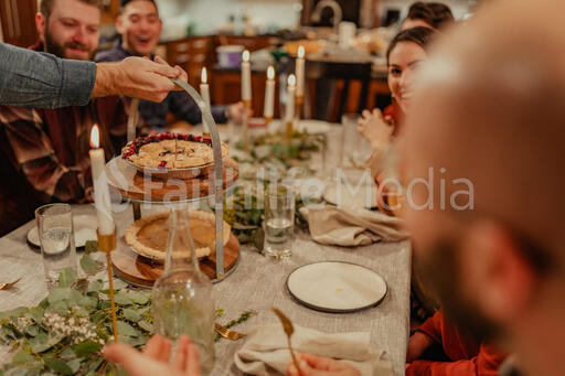 Man Serving Up Pie at the Thanksgiving Table