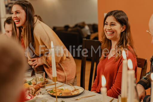 Friends Laughing and Enjoying Thanksgiving Dinner Together