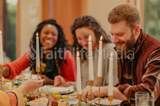Friends Laughing and Enjoying a Meal Together
