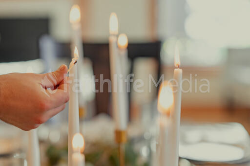 Man Lighting Candles at the Thanksgiving Table