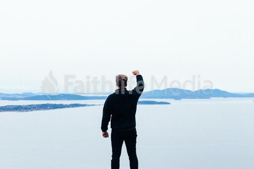 Man Raising His Hands in Worship Outside
