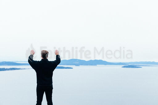 Man Raising His Hands in Worship Outside