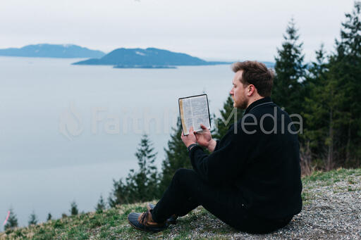 Man Reading the Bible Outside