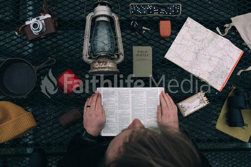 Man Reading the Bible while Camping