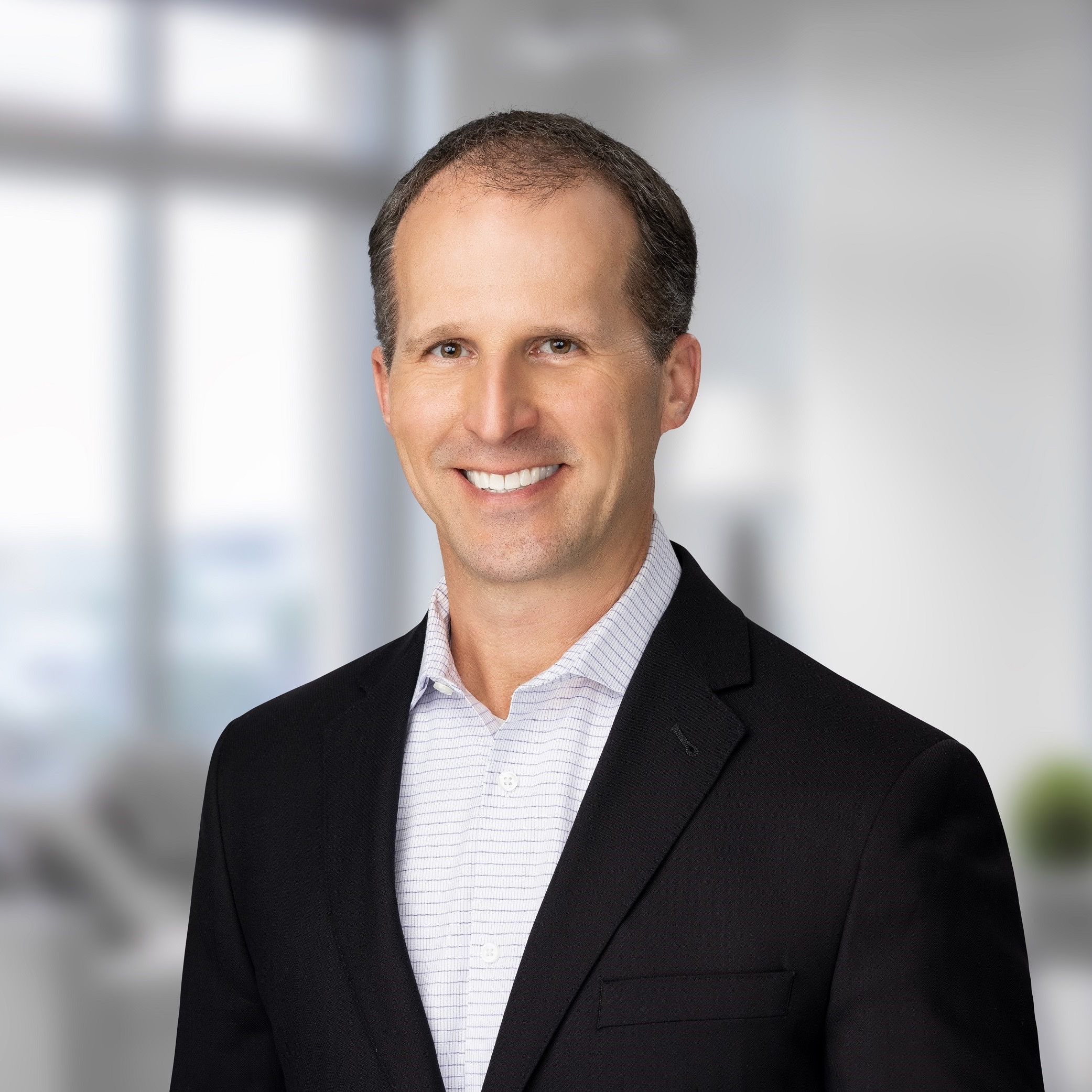 A headshot of Chris Migura, Logos CEO